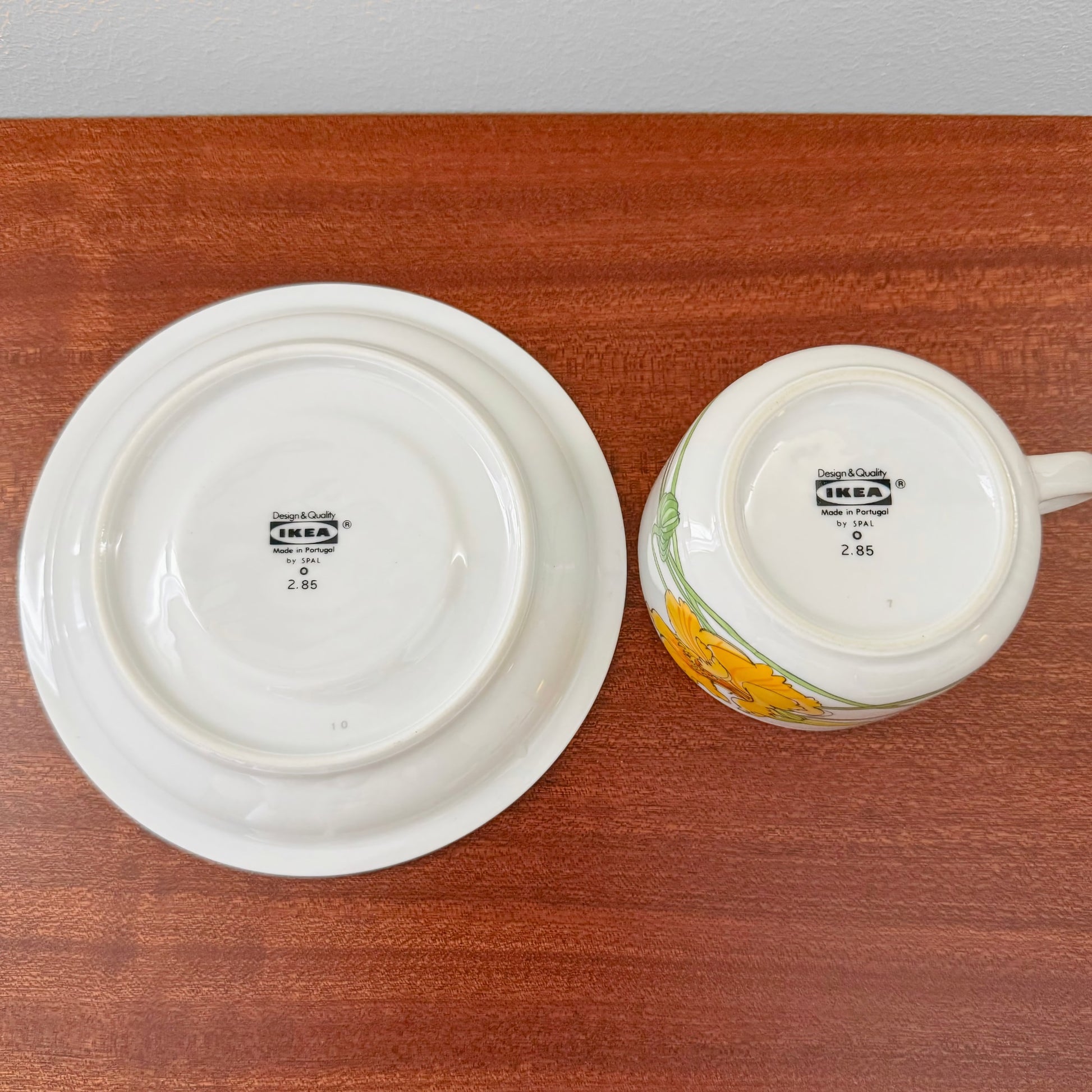 IKEA Krasse Herrgården Tea Cup with Saucer showing bottom stamps with vintage design marks, placed on a wooden surface, highlighting authentic Nordic craftsmanship.