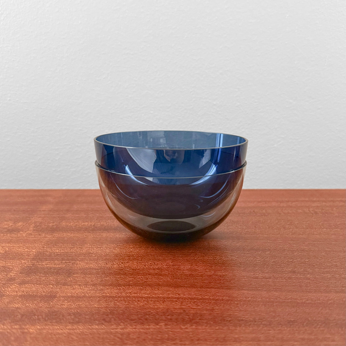 Kaj Franck 1340 Glass Dessert Bowls pair of vintage blue and grey glass dessert bowls by Nuutajarvi Notsjo on a wooden table