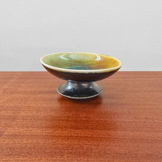 Liisa Hallamaa Arabia Finland Hand-Painted Candle Holder in ceramic, featuring a vintage hand-painted glaze with earthy green and yellow tones on a raised pedestal base.
