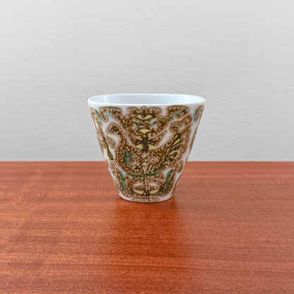 Nils Thorsson Royal Copenhagen Baca Small Vase (713/3216), ceramic vase with stylised bird motif in brown and green on a wooden surface.