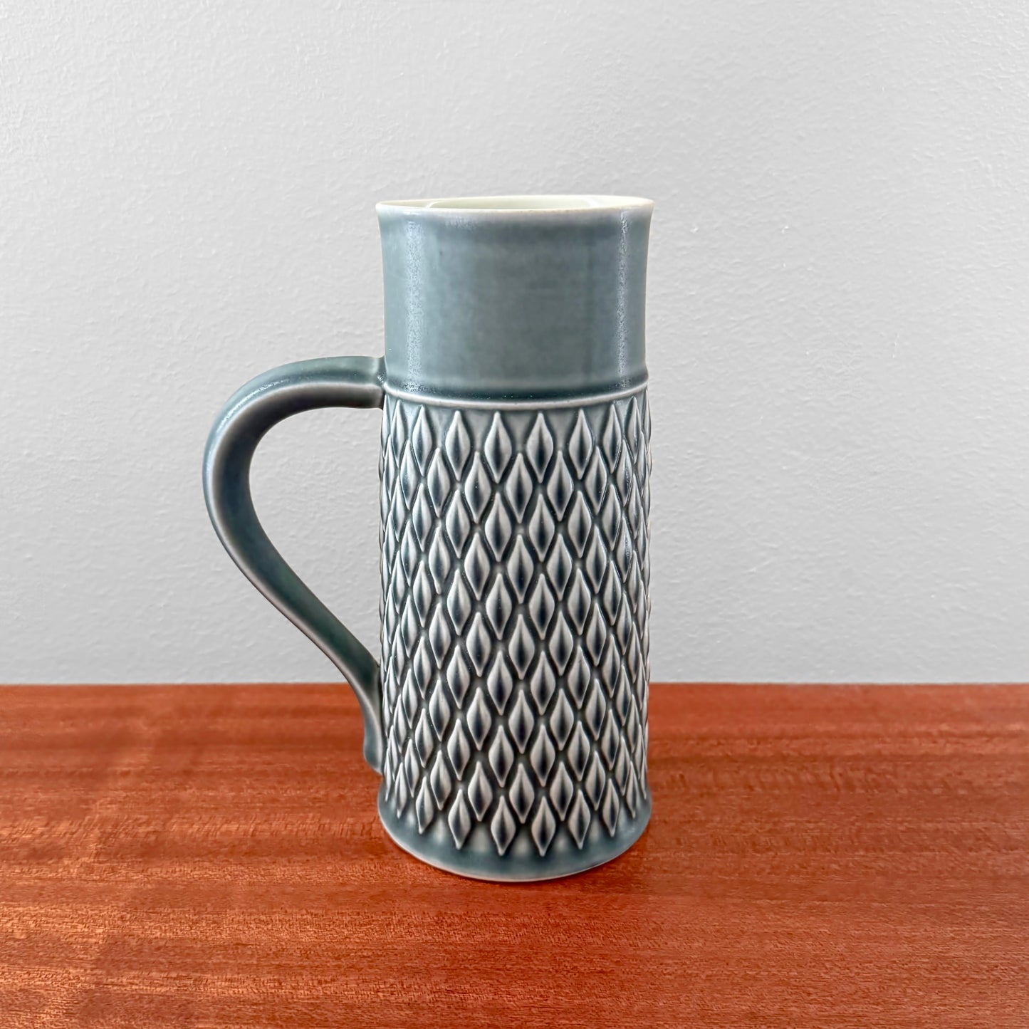 Quistgaard Relief Azure Pitcher in vintage ceramic with textured relief pattern and curved handle, showcasing Scandinavian mid-century design in a rare azure color.