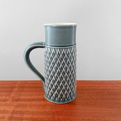 Quistgaard Relief Azure Pitcher in vintage ceramic with textured relief pattern and curved handle, showcasing Scandinavian mid-century design in a rare azure color.