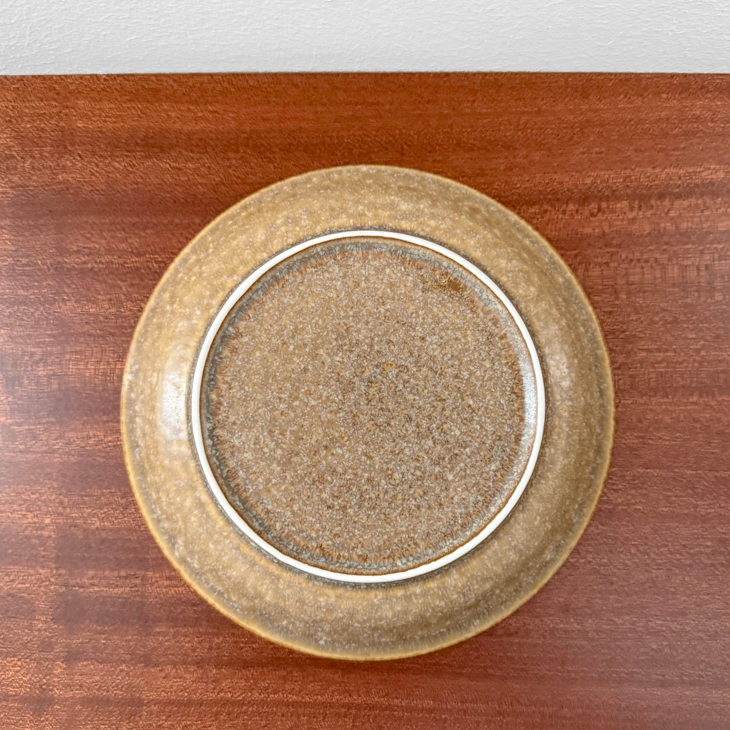 Quistgaard Relief Coffee Cup Trio Set vintage ceramic cake plate with textured brown glaze on wooden surface, showcasing classic Scandinavian drinkware craftsmanship.
