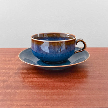 Rörstrand Litorina Blue Tea Cup with Saucer in rich blue glazed ceramic on a wooden table vintage Swedish Nordic tableware by Carl-Harry Stålhane