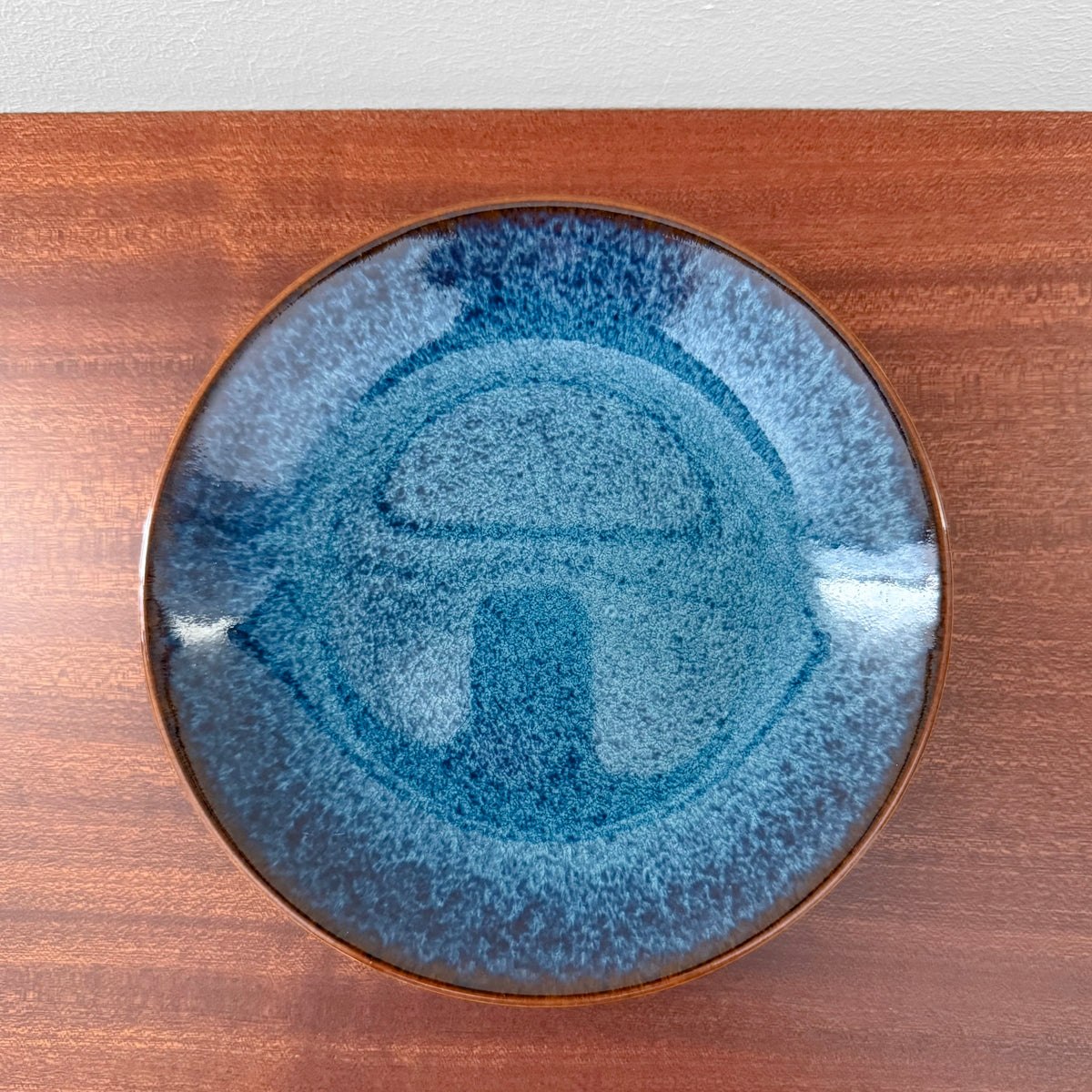 Rörstrand Litorina Blue Tea Cup Trio Set blue glazed cake plate with textured Nordic design and brown rim shown on a wooden surface