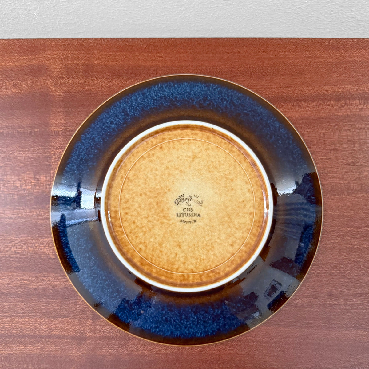 Rörstrand Litorina Blue Tea Cup Trio Set showing the maker's mark on the underside of a blue glazed saucer and cake plate