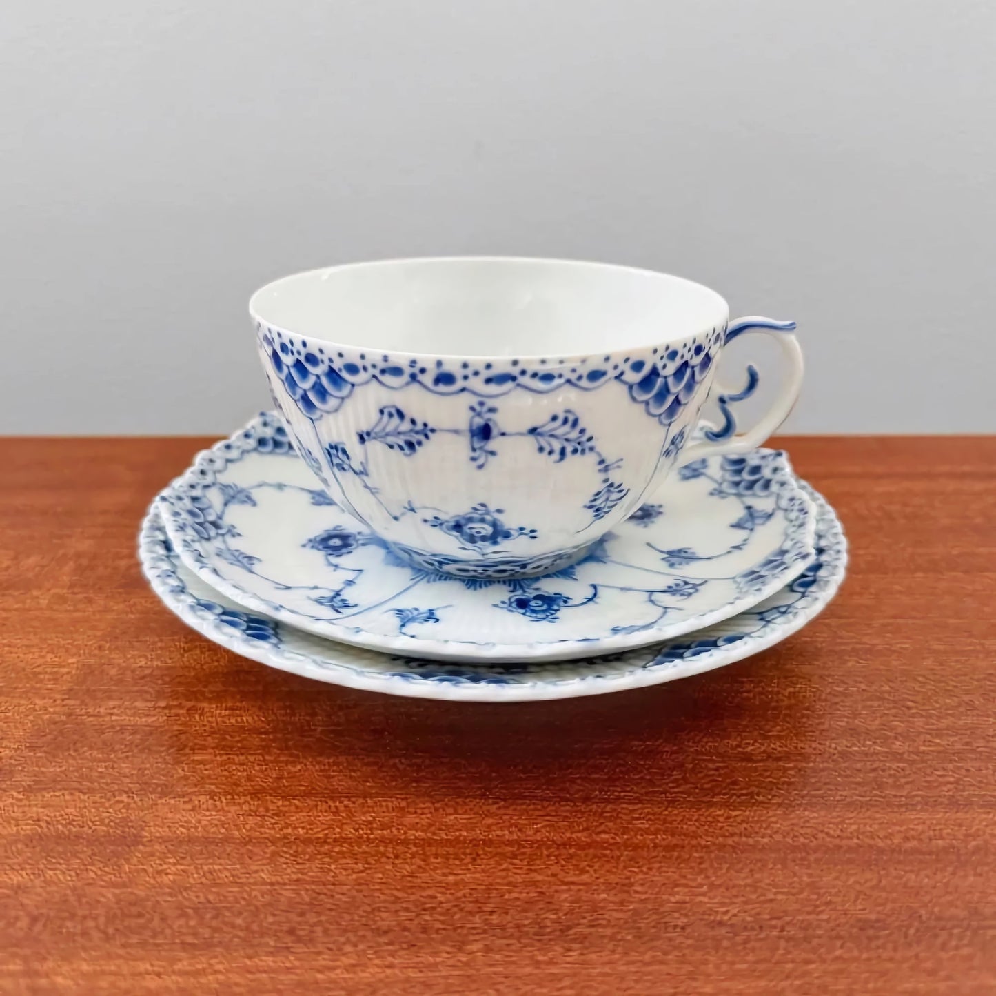 Royal Copenhagen Blue Fluted Full Lace Large Tea Cup Trio Set featuring vintage Danish ceramic craftsmanship with intricate blue floral and lace patterns on cup, saucer, and plate.