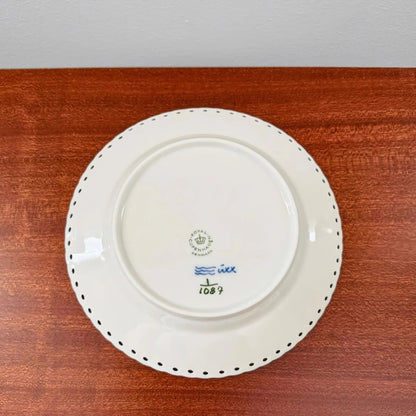 Back view of a ceramic cake plate from the Royal Copenhagen Blue Fluted Full Lace Large Tea Cup Trio Set showing maker's marks and decorative scalloped edge on wood surface.