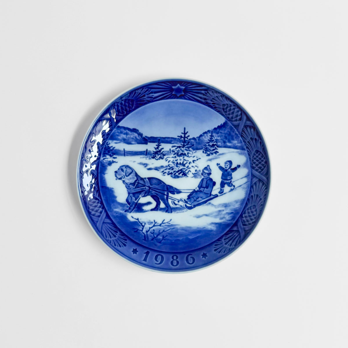 Royal Copenhagen Christmas Plates decorative dish in blue and white with a winter sledding scene and 1986 date border Nordic tableware vintage home decor