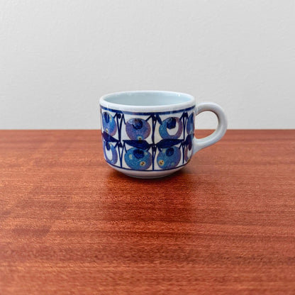 Royal Copenhagen Tenera Coffee Cup (510/3287) vintage ceramic drinkware with a blue stylised blueberry motif and white handle on a wooden table