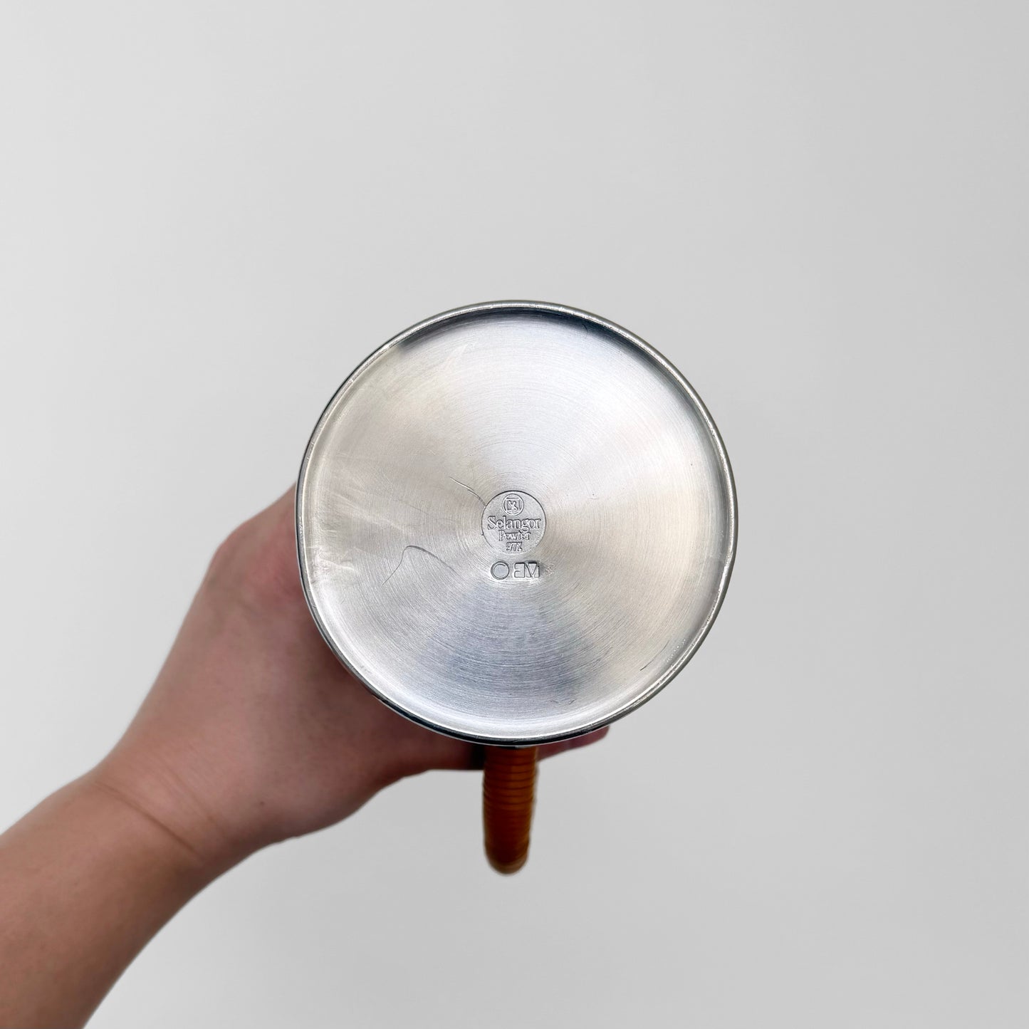 Bottom view of the Royal Selangor Erik Magnussen Pewter Coffee Set showing hallmark and wooden handle against a plain background.