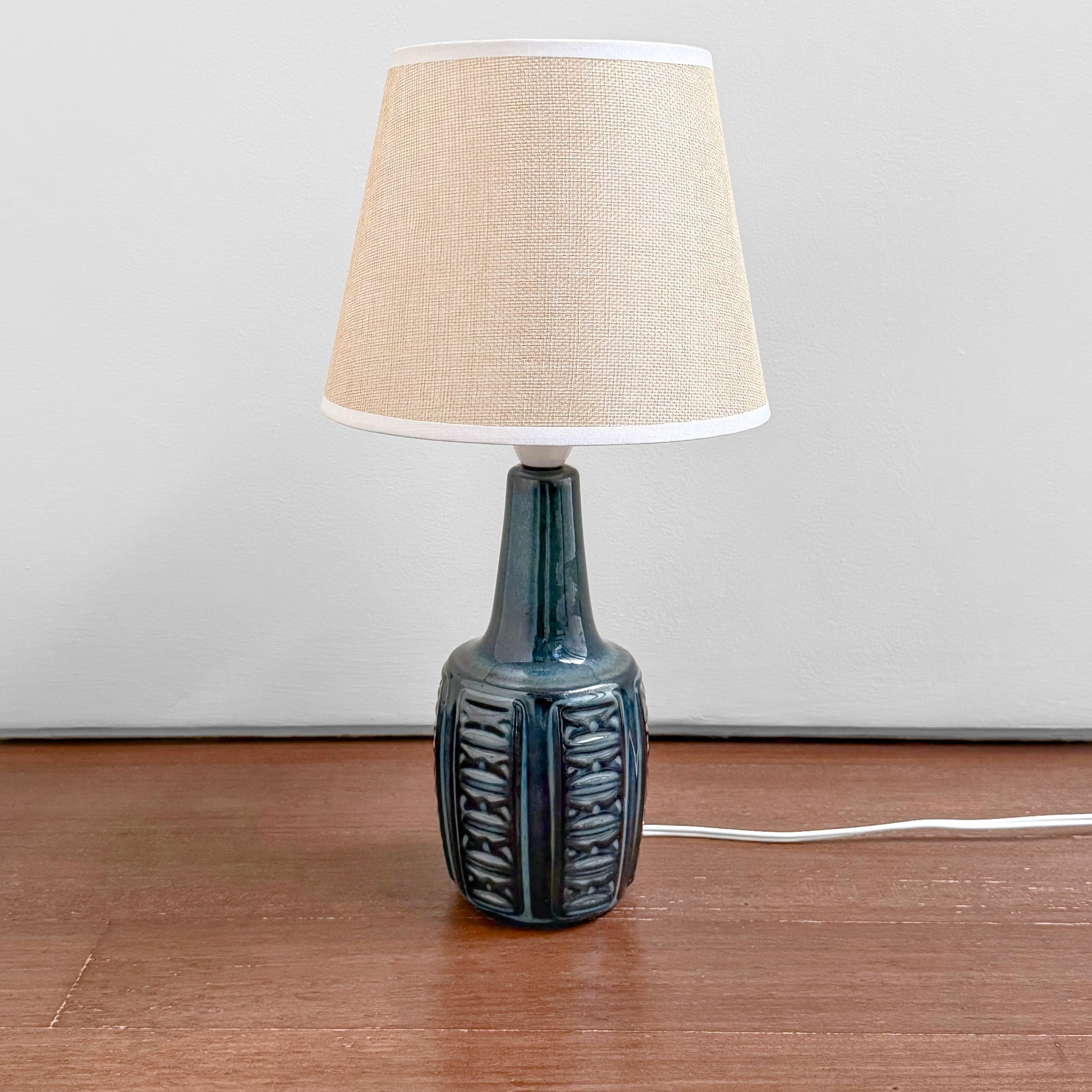 Søholm 1038 Blue Stoneware Table Lamp with ceramic blue glazed base featuring textured vertical patterns and a beige fabric shade, vintage Nordic lighting design.