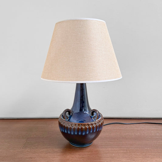Søholm 1059 Blue Stoneware Table Lamp with blue ceramic base featuring vintage Nordic design and a beige fabric shade, suitable for home decor and lighting.