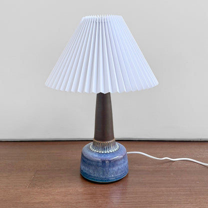 Søholm 1080 Dark Blue Stoneware Table Lamp with a pleated white plastic shade, featuring vintage Nordic ceramic craftsmanship and a glazed dark blue base.