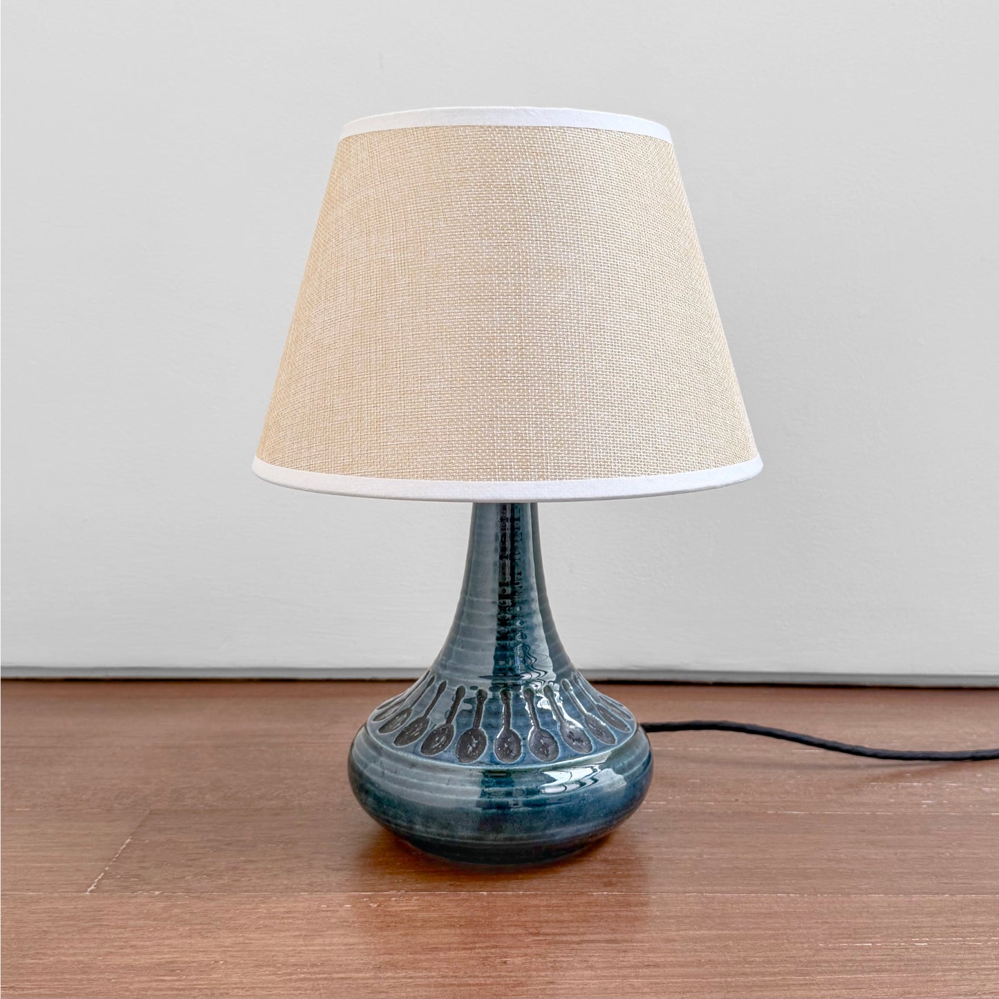 Søholm 1213 Blue Stoneware Table Lamp with a blue glazed ceramic base featuring decorative patterns and a beige fabric shade, showcasing vintage Nordic design.