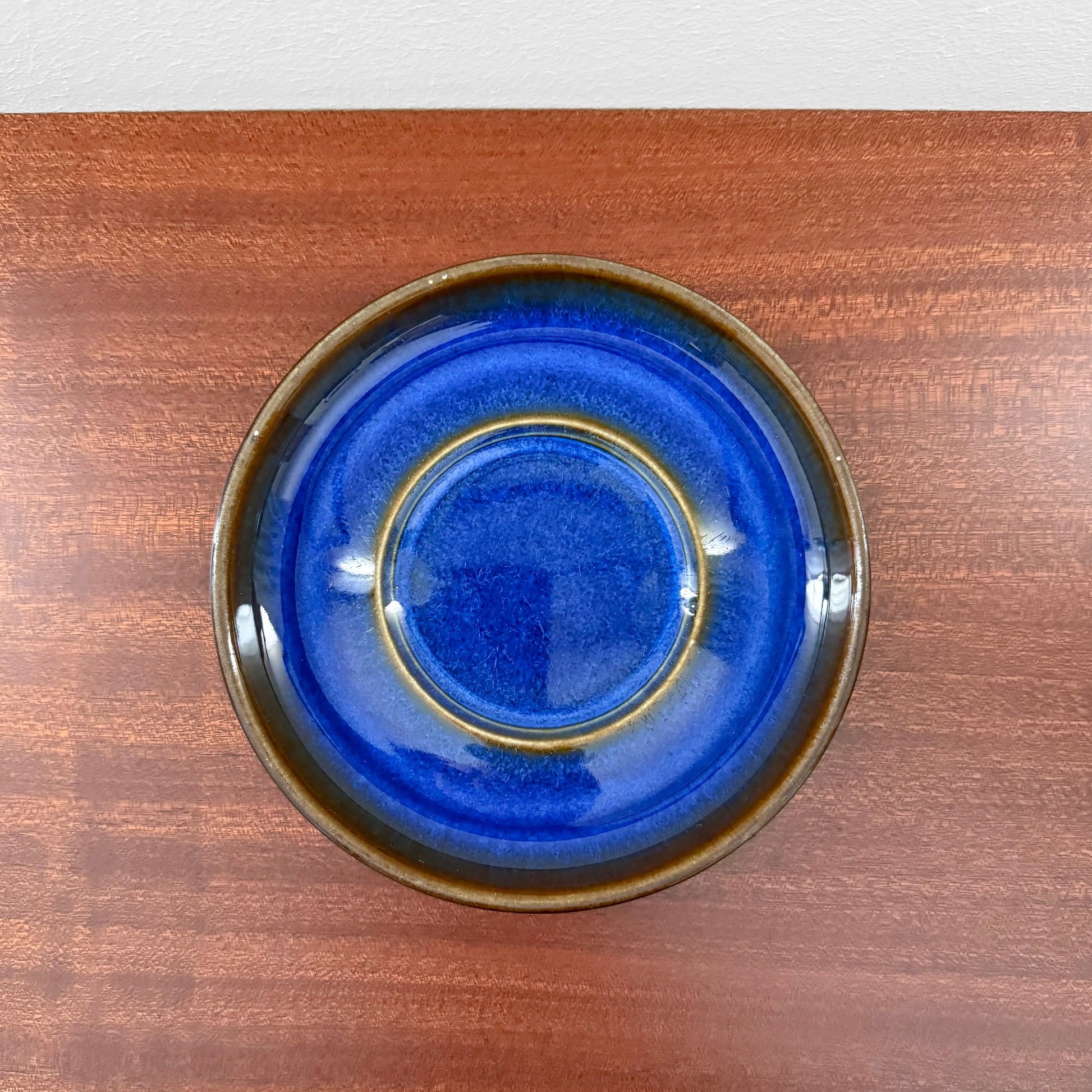 Søholm Granit Blue Tea Cup with Saucer showcasing a deep blue ceramic saucer with brown edges, highlighting vintage Scandinavian craftsmanship and Nordic design.