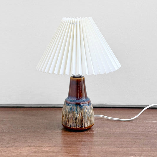 Søholm Manilla Brown Stoneware Table Lamp with multitone ceramic base and white pleated plastic shade, showcasing vintage Scandinavian design and Nordic craftsmanship.