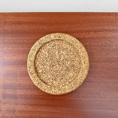 Round cork coaster displayed on a wooden surface, part of the Signe Persson-Melin Boda Nova Glass Tea Cup with Cork Coaster set, showcasing vintage Nordic design and natural materials.