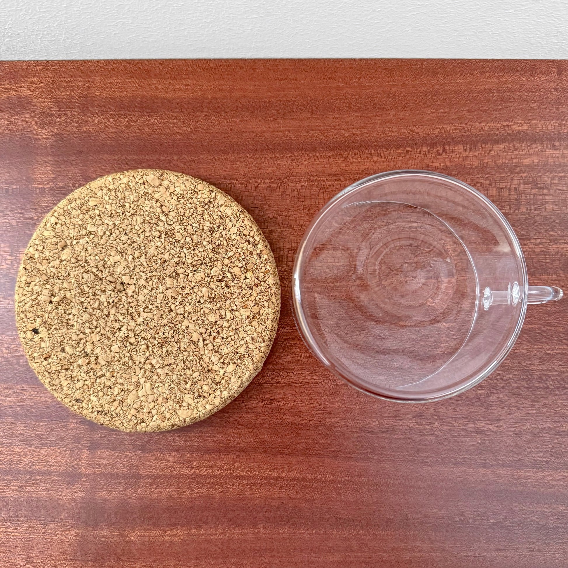 Signe Persson-Melin Boda Nova Glass Tea Cup with Cork Coaster displayed on a wooden surface, showcasing clear glass craftsmanship and a natural cork coaster.
