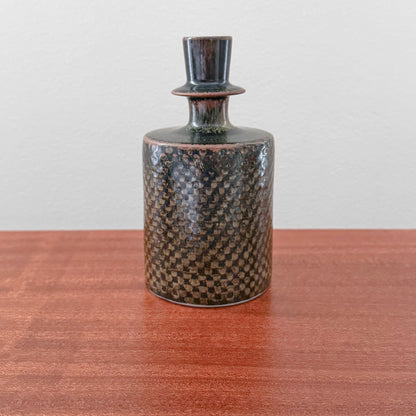 Stig Lindberg Gustavsberg Brown Stoneware Vase vintage brown ceramic vase with textured checkerboard glaze and narrow neck displayed on a wooden table