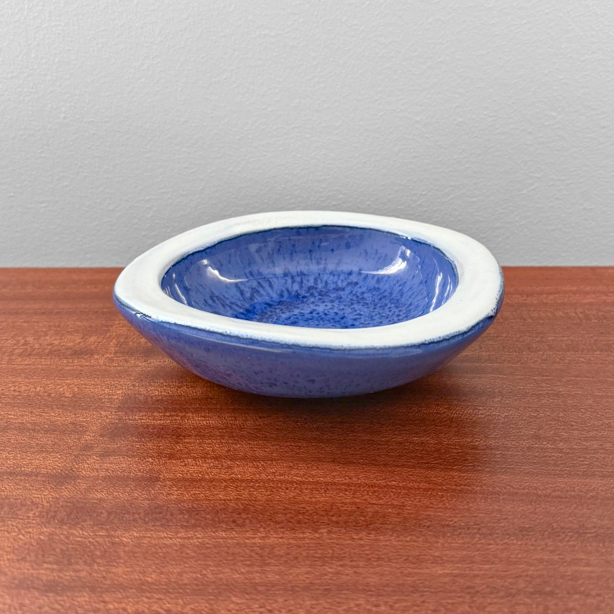 Swedish Blue Decorative Bowl in rich blue glaze with a white rim displayed on a wooden surface as vintage Scandinavian home decor