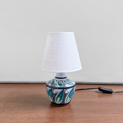Swedish Botanical Table Lamp vintage ceramic lamp with sgraffito leaf motif and new fabric shade on a wooden surface