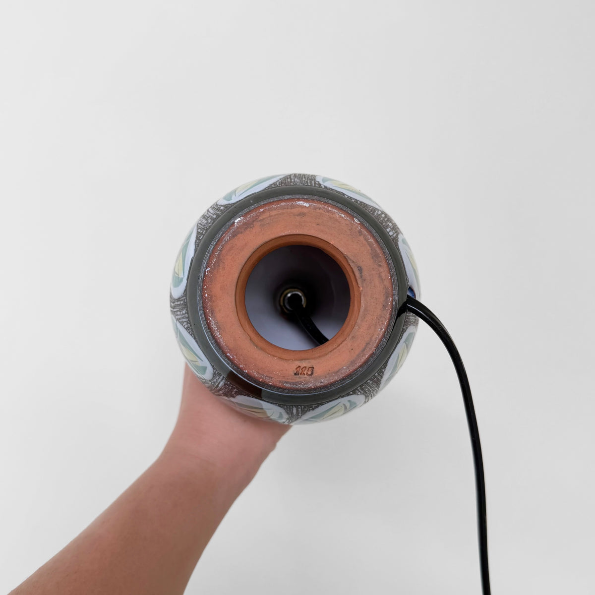 Swedish Botanical Table Lamp underside showing its ceramic base with sgraffito leaf motif, central bulb socket, and black electrical cord